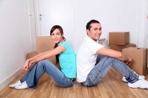 Protected movers carrying furniture with safety equipment