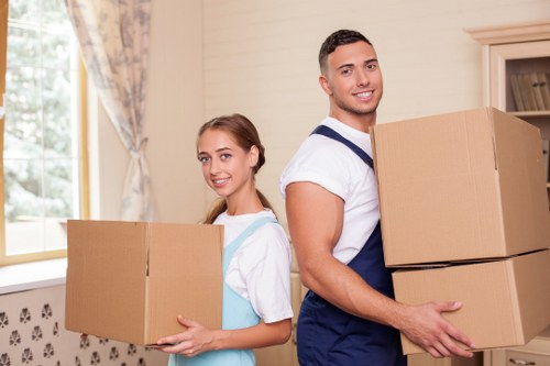 Removal crew carrying furniture from a Battersea flat